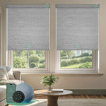Motorised blockout roller blinds in foggy grey fabric, installed in a living room, offering soft daylight privacy with smart app and remote control.