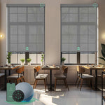 Motorised sunscreen roller blinds with 3% openness in grey fabric, filtering daylight while maintaining outdoor views and privacy