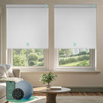 White motorised vinyl blockout roller blinds installed in a living room, offering full blackout, privacy, and quiet smart control