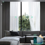 Motorised sheer curtains, hardwired and installed above a sliding door, provide privacy and light filtering