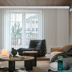 Rice white motorised veri shades are installed in the living room, providing privacy and light control.